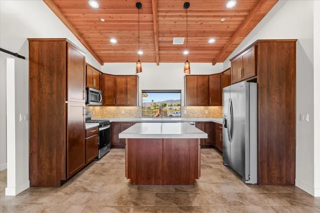 a kitchen with refrigerator and cabinets