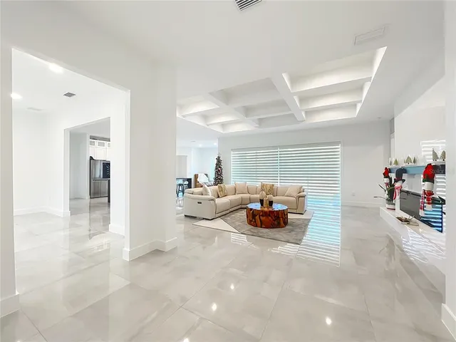 a kitchen with stainless steel appliances a table and chairs in it