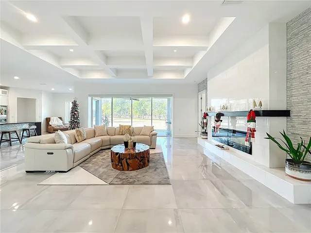 a large white kitchen with a large window and cabinets