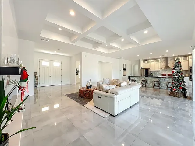 a spacious bedroom with a bed and glass door