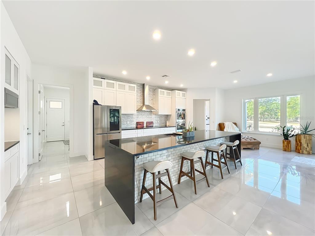 540 Northwest 165th Ct Road Dunnellon, FL 34432 - Photo 25 of 85 a kitchen with stainless steel appliances a table and chairs in it