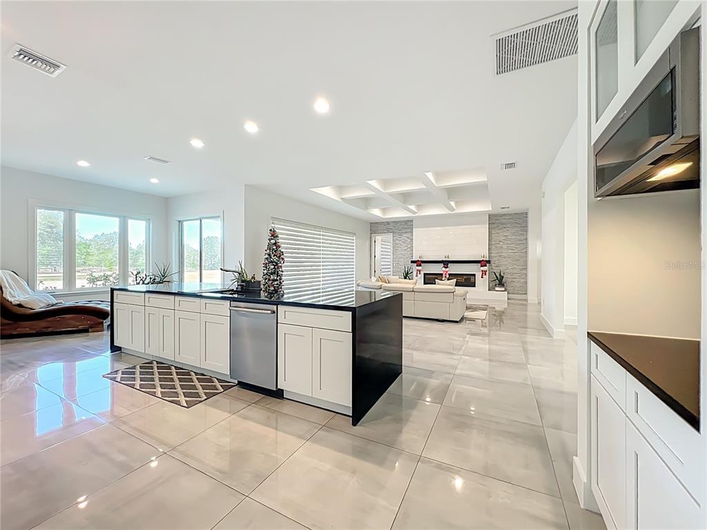 540 Northwest 165th Ct Road Dunnellon, FL 34432 - Photo 27 of 85 a large white kitchen with a large window and cabinets