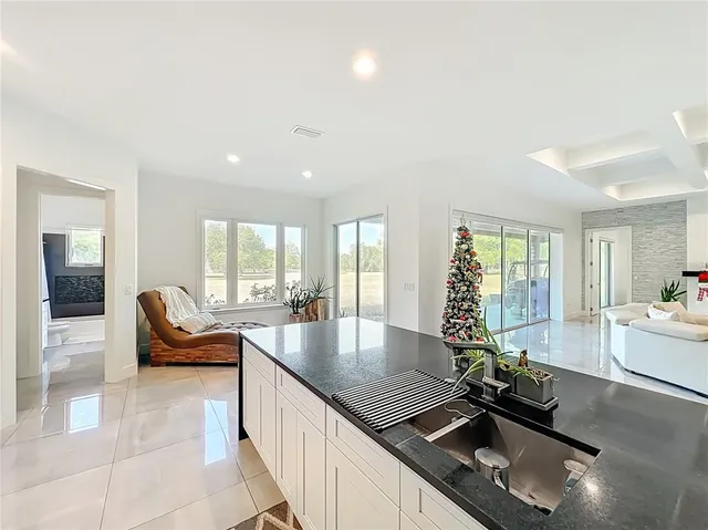 a view of kitchen with refrigerator and chairs