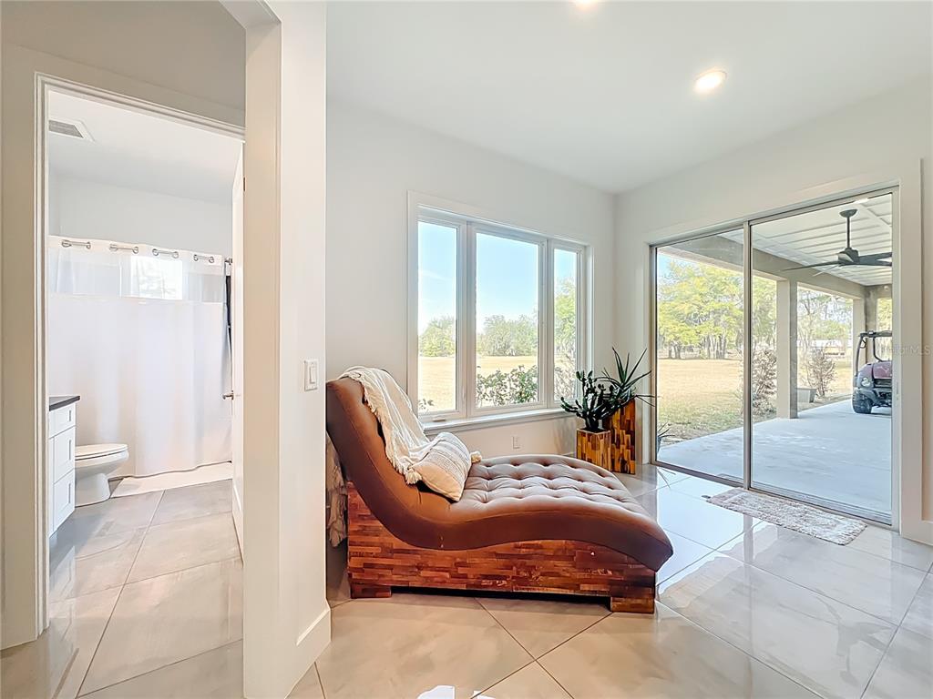 540 Northwest 165th Ct Road Dunnellon, FL 34432 - Photo 30 of 85 a spacious bedroom with a bed and glass door