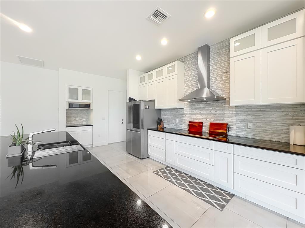 540 Northwest 165th Ct Road Dunnellon, FL 34432 - Photo 31 of 85 a kitchen with granite countertop a sink stainless steel appliances and cabinets