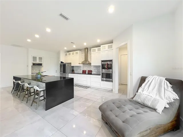 a kitchen with stainless steel appliances granite countertop a sink stove and cabinets