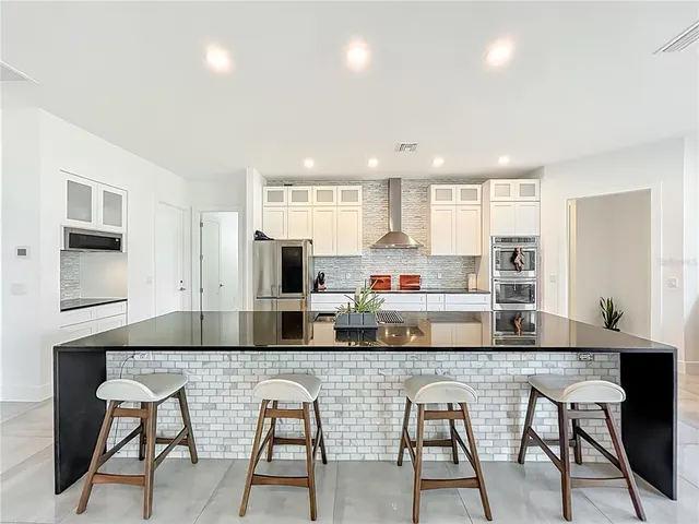 a kitchen with a sink a refrigerator and cabinets