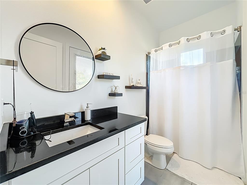 540 Northwest 165th Ct Road Dunnellon, FL 34432 - Photo 34 of 85 a bathroom with a sink a toilet and a mirror