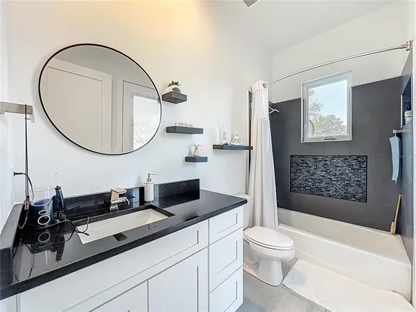 a bedroom with a bed and flat screen tv