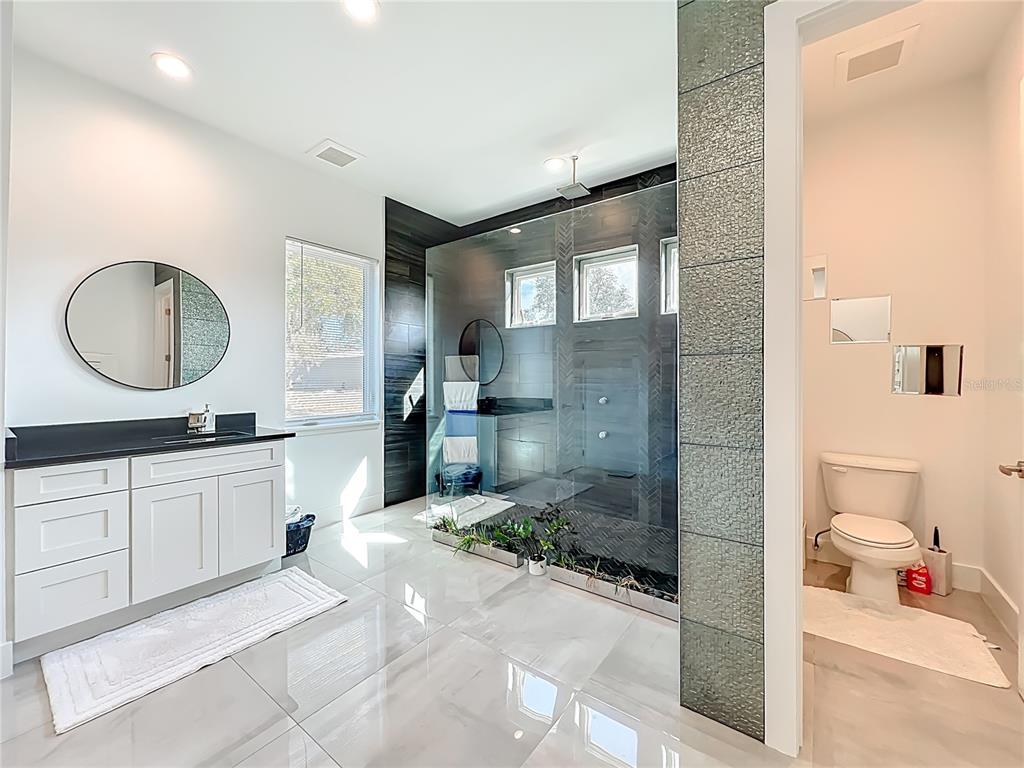 540 Northwest 165th Ct Road Dunnellon, FL 34432 - Photo 38 of 85 a bathroom with a sink mirror and a shower