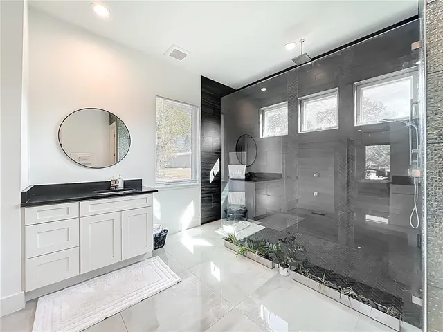 a bedroom with a bed and flat screen tv