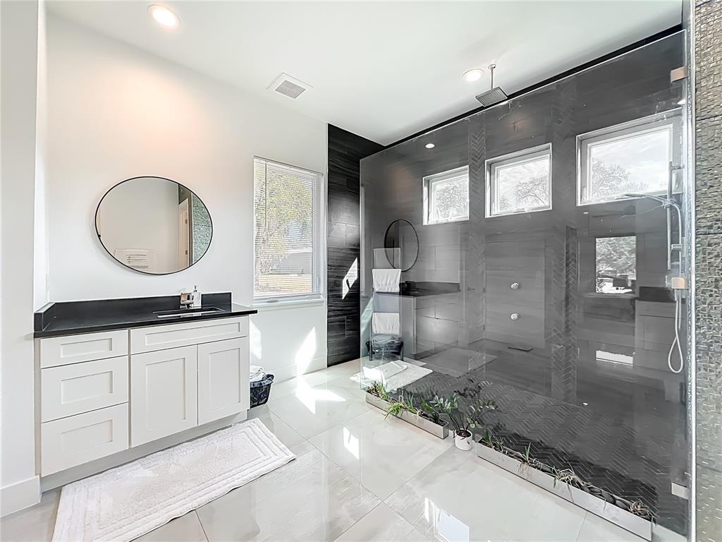 540 Northwest 165th Ct Road Dunnellon, FL 34432 - Photo 39 of 85 a bathroom with a granite countertop sink a mirror and a shower
