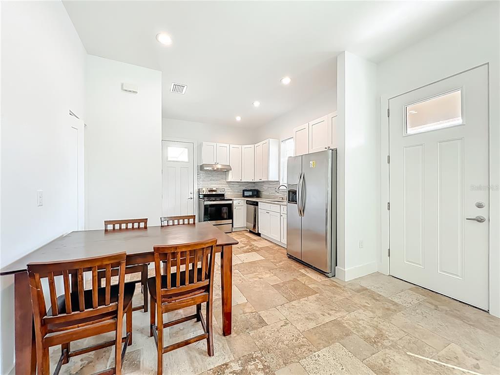 540 Northwest 165th Ct Road Dunnellon, FL 34432 - Photo 44 of 85 a view of kitchen with refrigerator and chairs