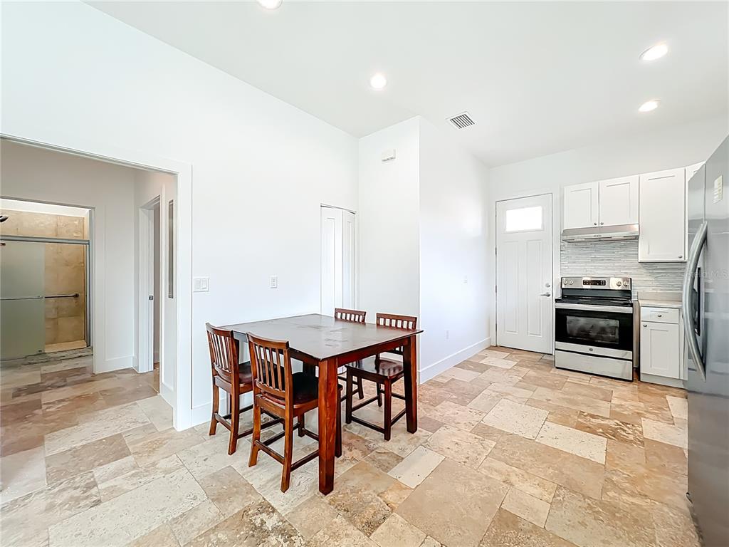 540 Northwest 165th Ct Road Dunnellon, FL 34432 - Photo 45 of 85 a kitchen with stainless steel appliances a sink a stove a refrigerator cabinets and dining table