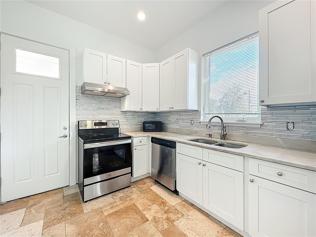 540 Northwest 165th Ct Road Dunnellon, FL 34432 - Photo 47 of 85 a kitchen with stainless steel appliances granite countertop a sink stove and cabinets