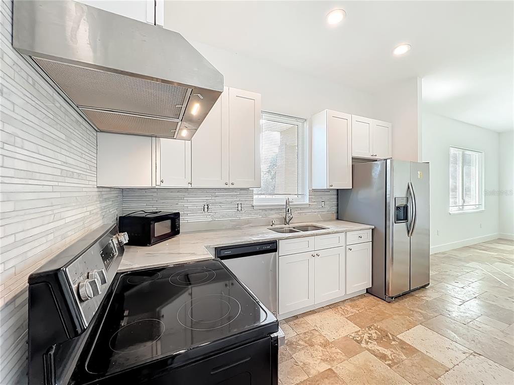 540 Northwest 165th Ct Road Dunnellon, FL 34432 - Photo 48 of 85 a kitchen with a sink a refrigerator and cabinets