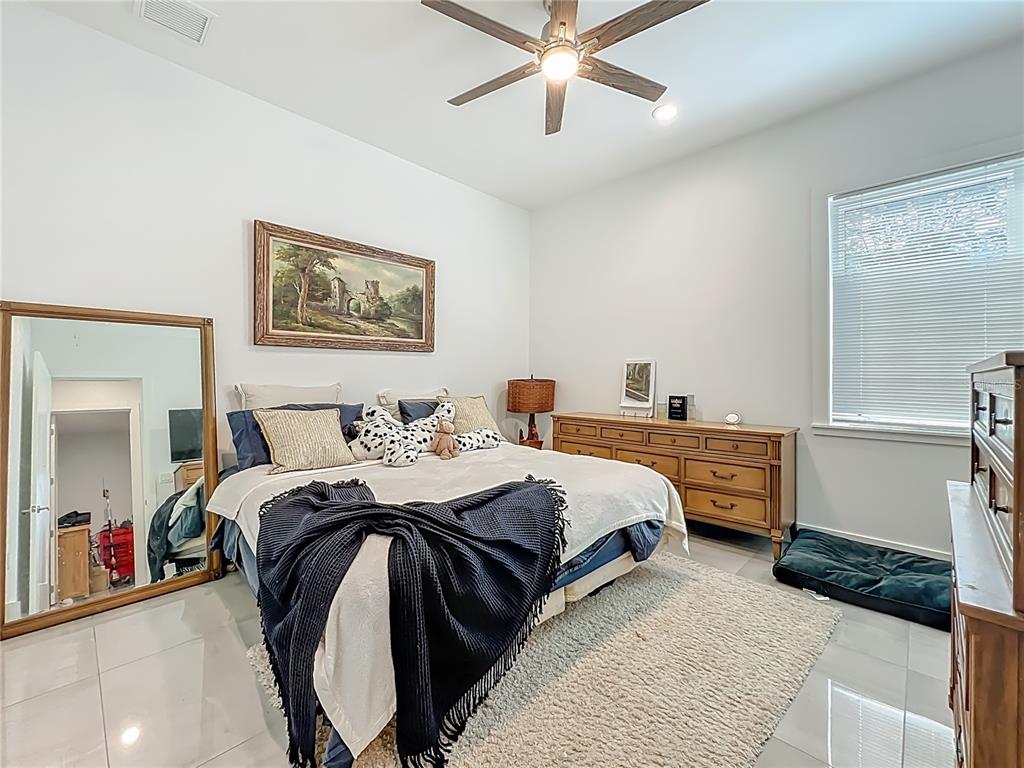 540 Northwest 165th Ct Road Dunnellon, FL 34432 - Photo 56 of 85 a bed room with a bed and a chandelier