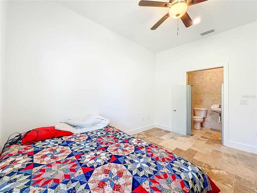 540 Northwest 165th Ct Road Dunnellon, FL 34432 - Photo 59 of 85 a bedroom with a bed and a chandelier