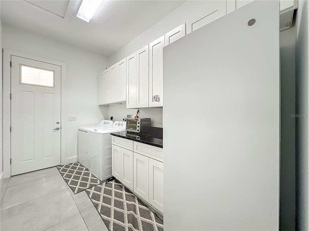 540 Northwest 165th Ct Road Dunnellon, FL 34432 - Photo 63 of 85 a kitchen with a sink a stove cabinets and a window