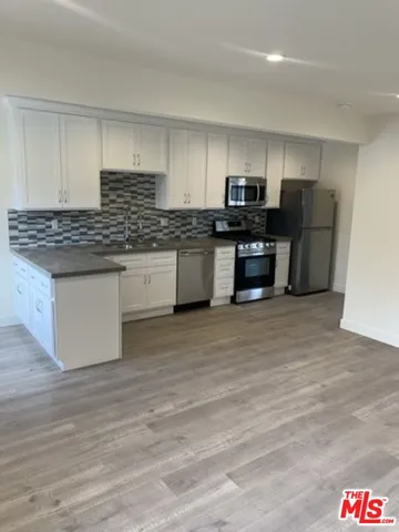 a kitchen with stainless steel appliances granite countertop a stove and a sink