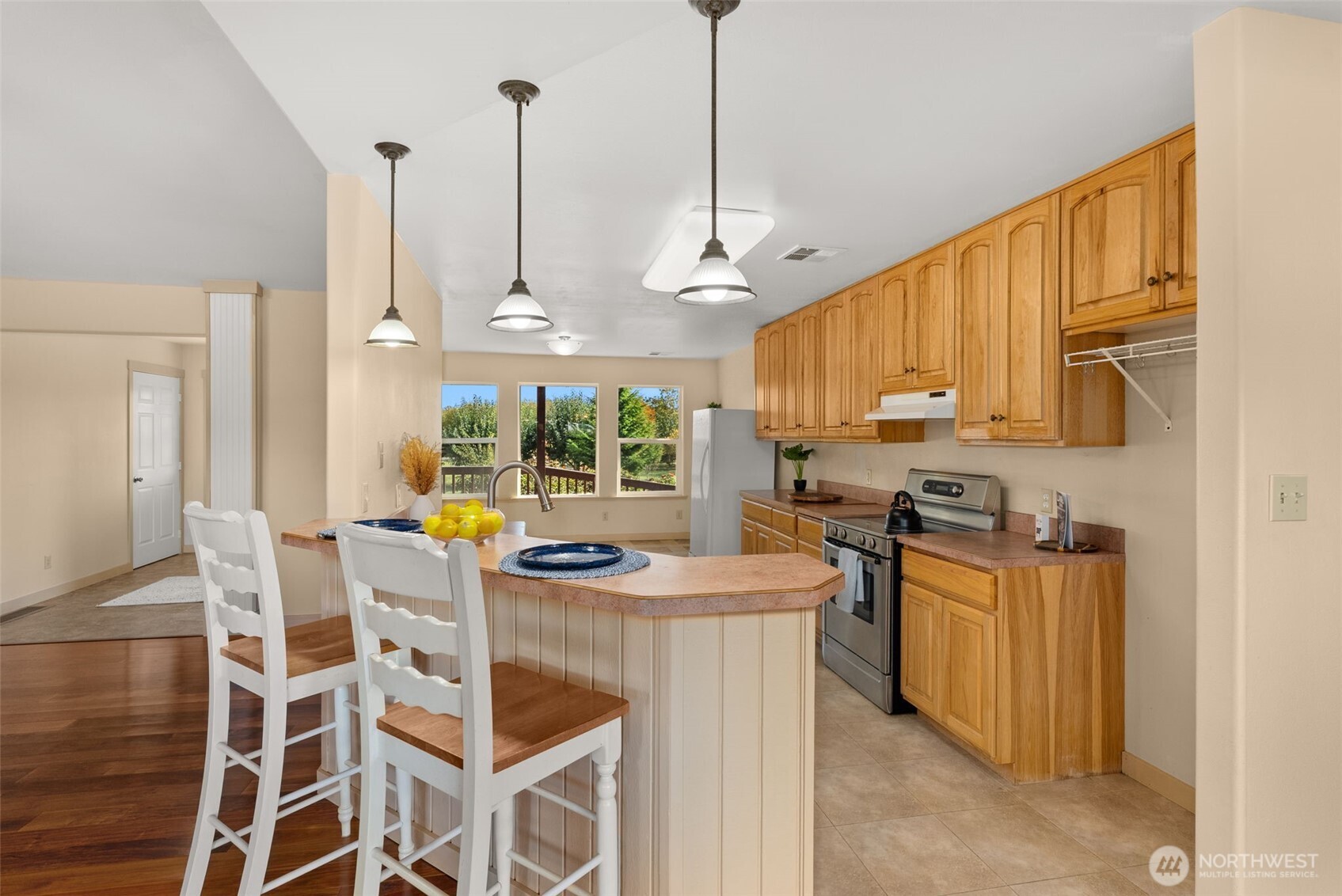 395 Ceres Hill Road Chehalis, WA 98532 - Photo 13 of 40 a view of a kitchen with kitchen island granite countertop wooden floor and stainless steel appliances