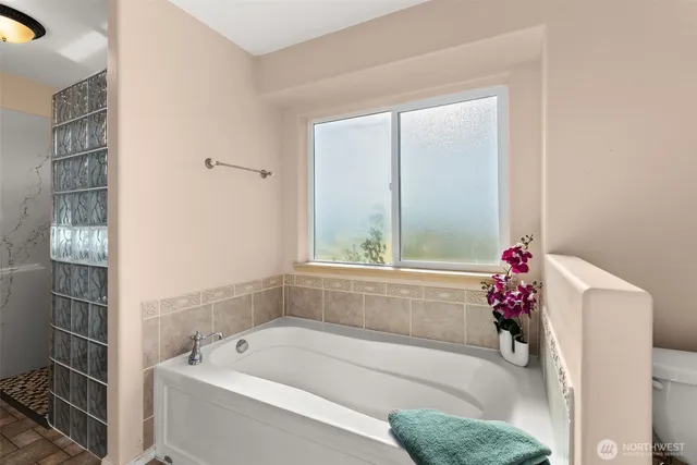 a bathroom with a bathtub and shower