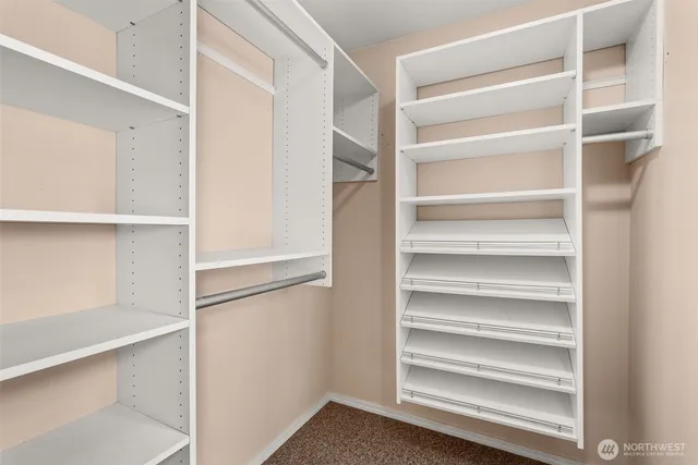 a view of walk in closet with empty racks