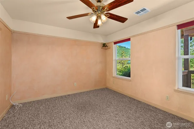 a view of room with window and ceiling fan
