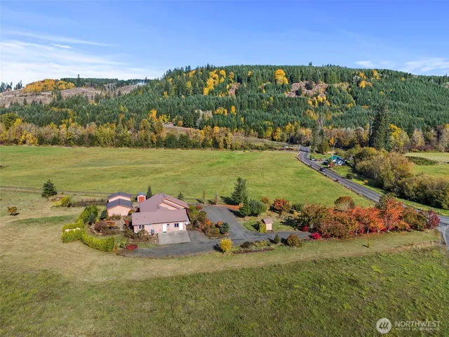 a front view of a house with a garden and ocean view