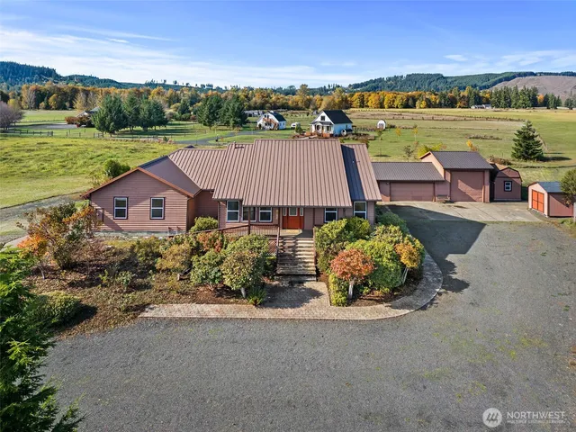 an aerial view of a house with garden space and ocean view