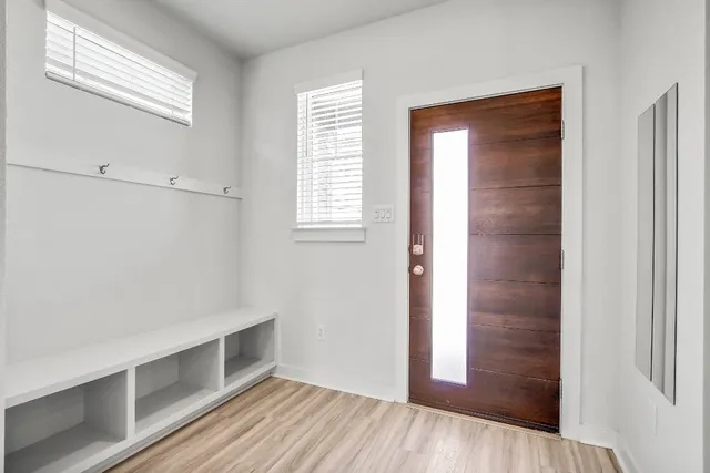 a view of a livingroom with wooden floor and ceiling fan