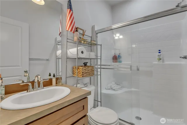 a bathroom with a sink a toilet and shower