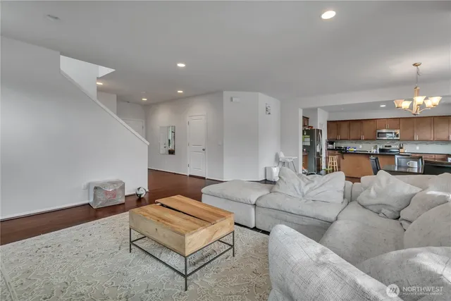 a living room with furniture and kitchen view