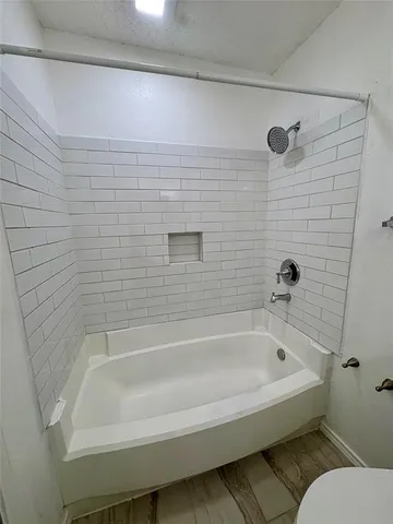a bathroom with a bathtub and shower