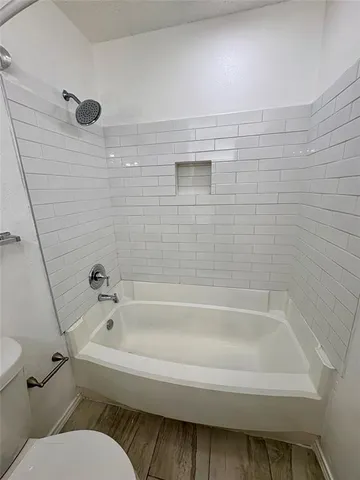 a bathroom with a toilet and a bathtub