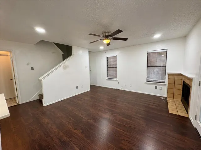 a view of a livingroom with wooden floor and a ceiling fan