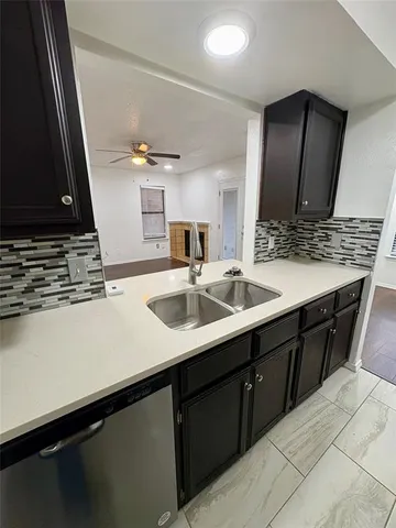 a kitchen with a sink and a refrigerator