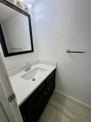 a bathroom with a sink vanity and mirror