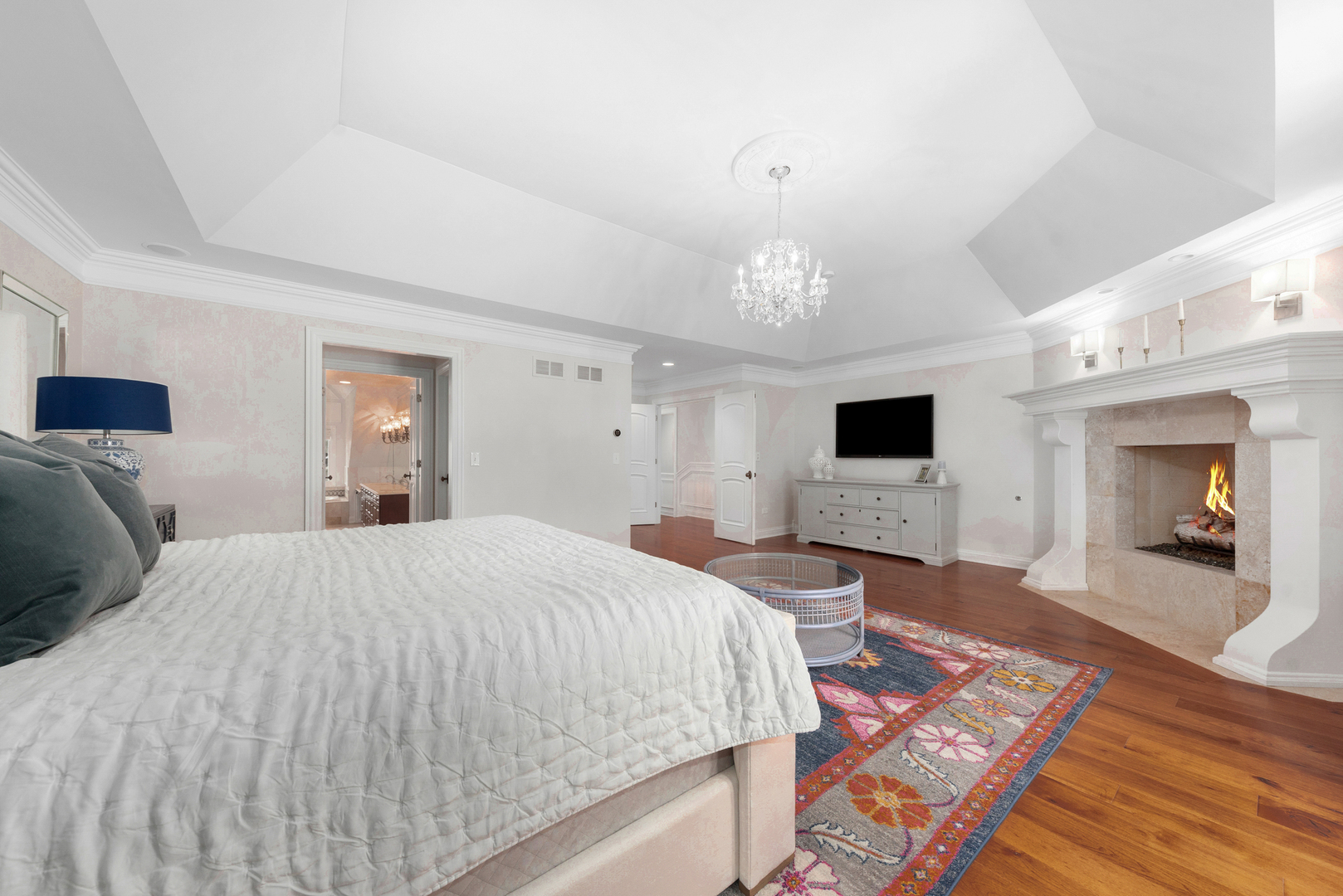 820 Wellner Road Naperville, IL 60540 - Photo 28 of 52 a spacious bedroom with a bed and a chandelier