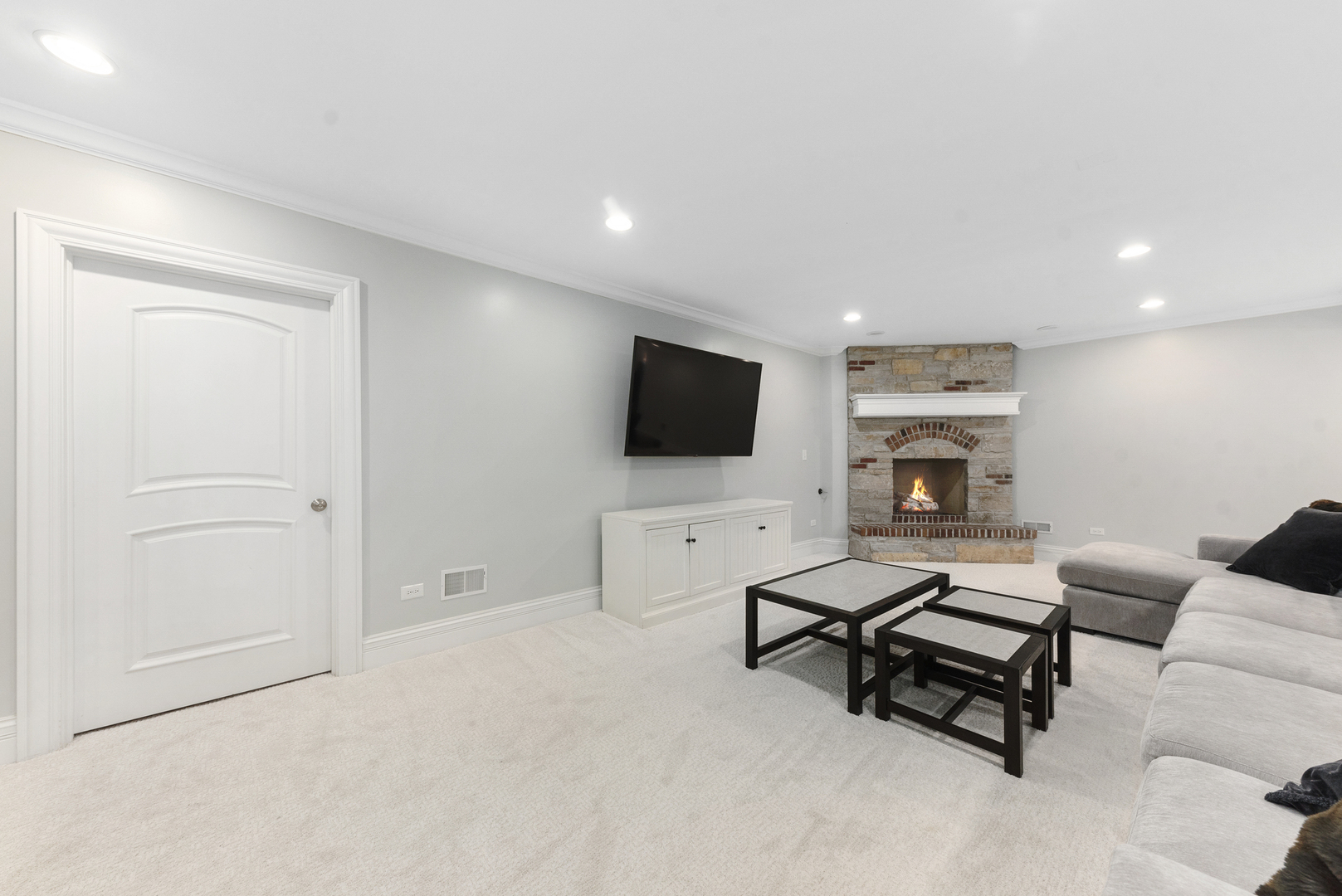 820 Wellner Road Naperville, IL 60540 - Photo 42 of 52 a living room with furniture and a flat screen tv