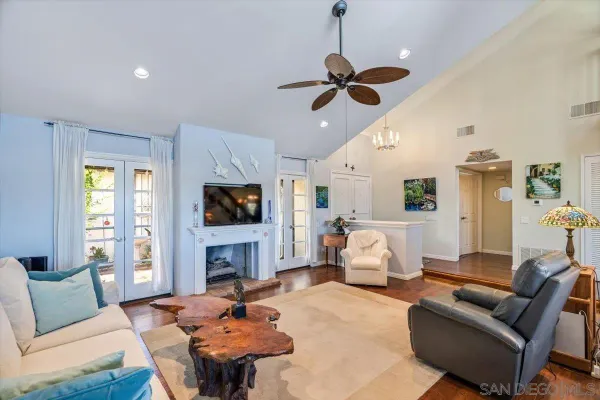 a living room with fireplace furniture and a flat screen tv