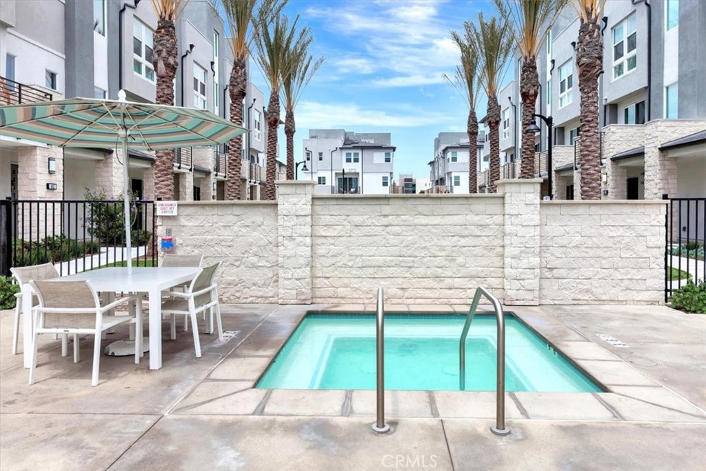 1810 West Bushell Street Anaheim, CA 92805 - Photo 32 of 36 a view of a patio with a table and chairs under an umbrella