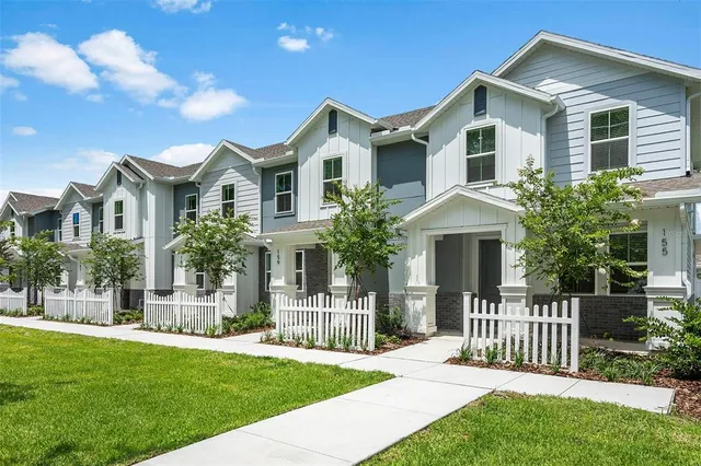 a front view of a house with a garden and plants