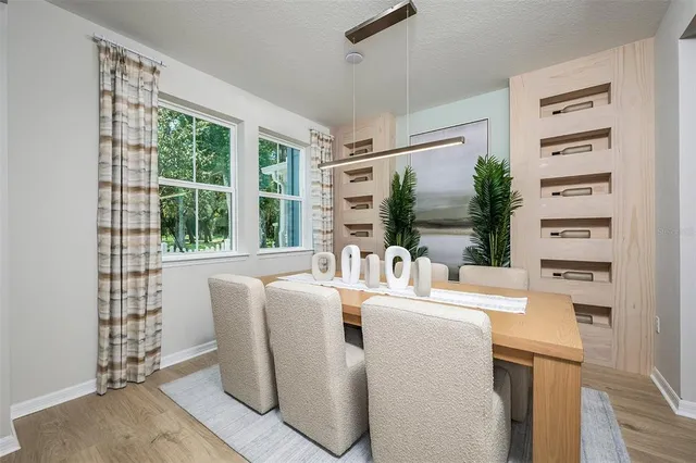 a dining room with furniture a large window and a rug