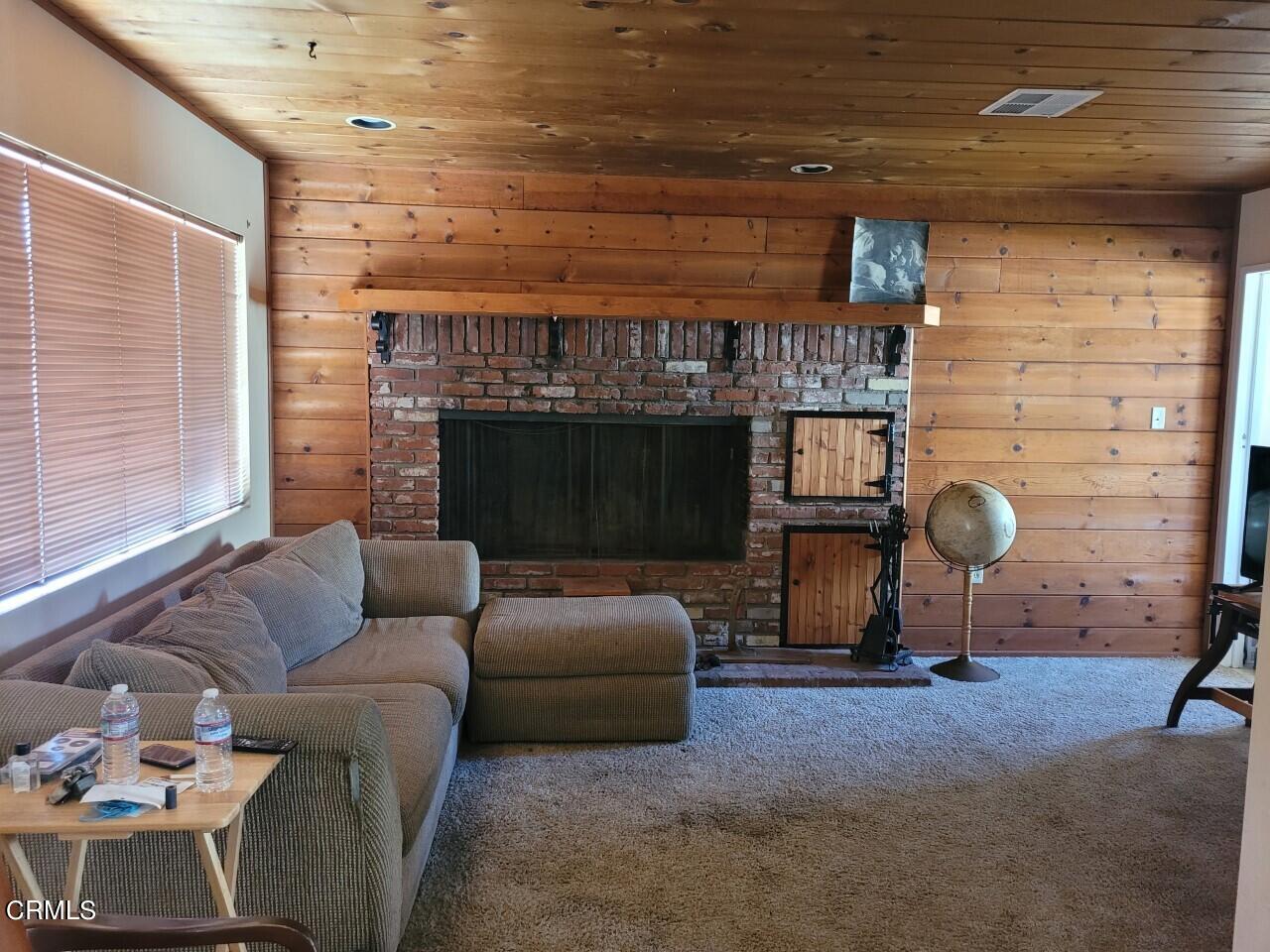 119 Lark Street Oxnard, CA 93033 - Photo 4 of 14 a living room with furniture a fireplace and a table