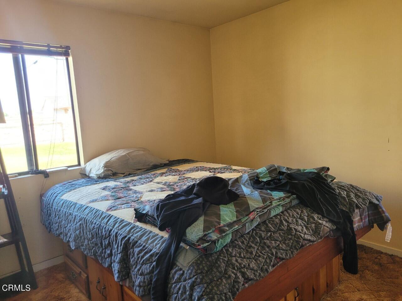 119 Lark Street Oxnard, CA 93033 - Photo 8 of 14 a bed sitting in a bedroom next to a window
