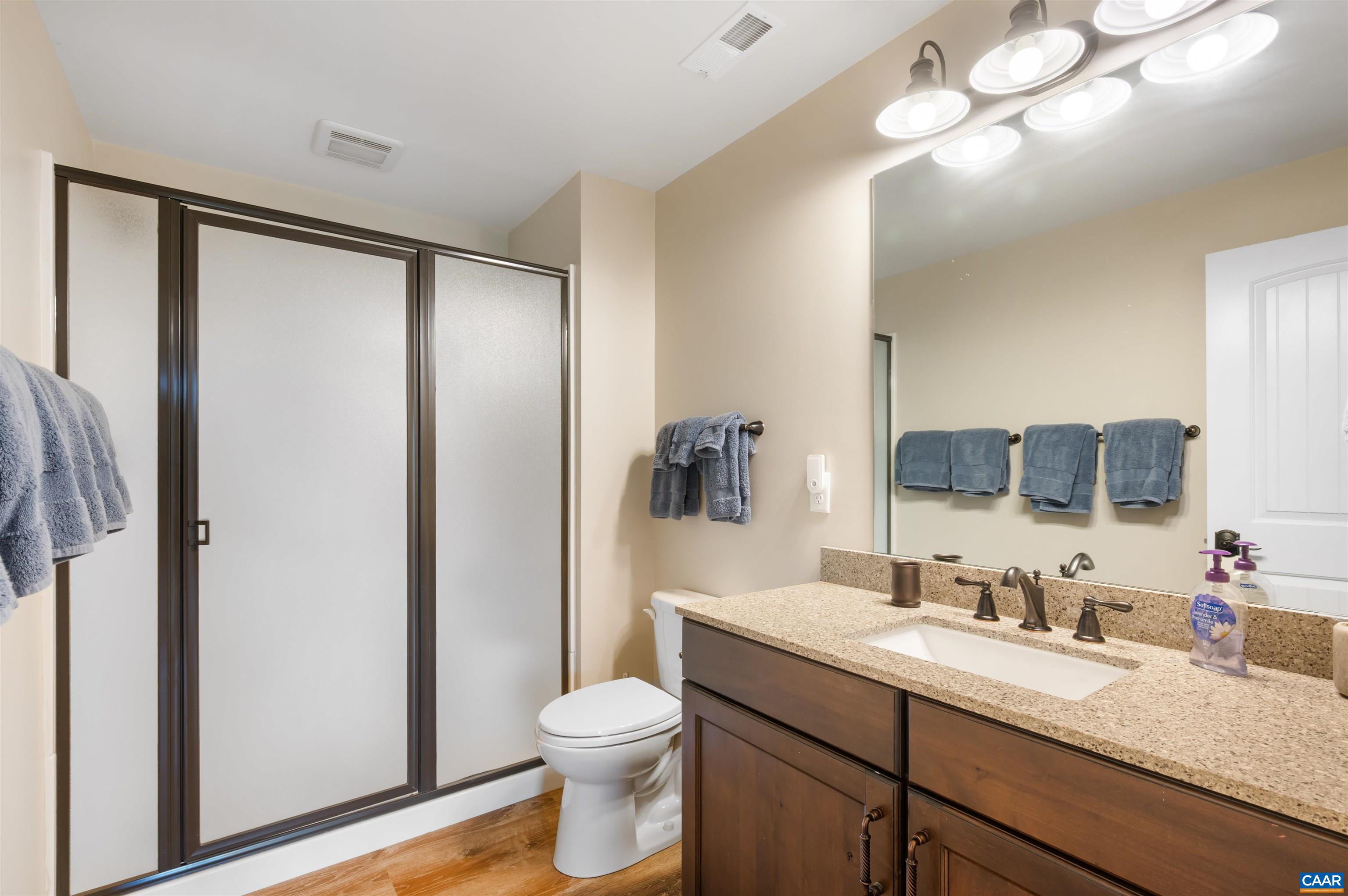 2236 Craigs Store Road Afton, VA 22920 - Photo 37 of 75 a bathroom with a granite countertop sink toilet and shower