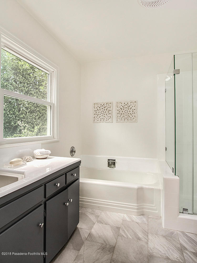3675 Greenhill Road Pasadena, CA 91107 - Photo 17 of 27 a bathroom with a granite countertop sink a toilet and bathtub