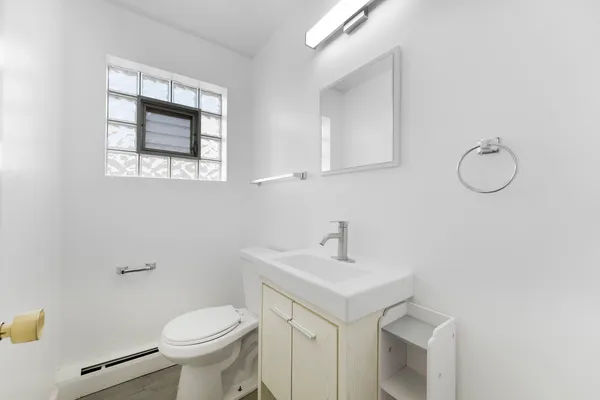 a bathroom with a sink a toilet and mirror
