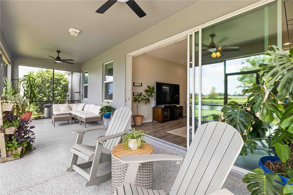 10920 79th Street East Parrish, FL 34219 - Photo 40 of 73 a living room with patio furniture and a floor to ceiling window